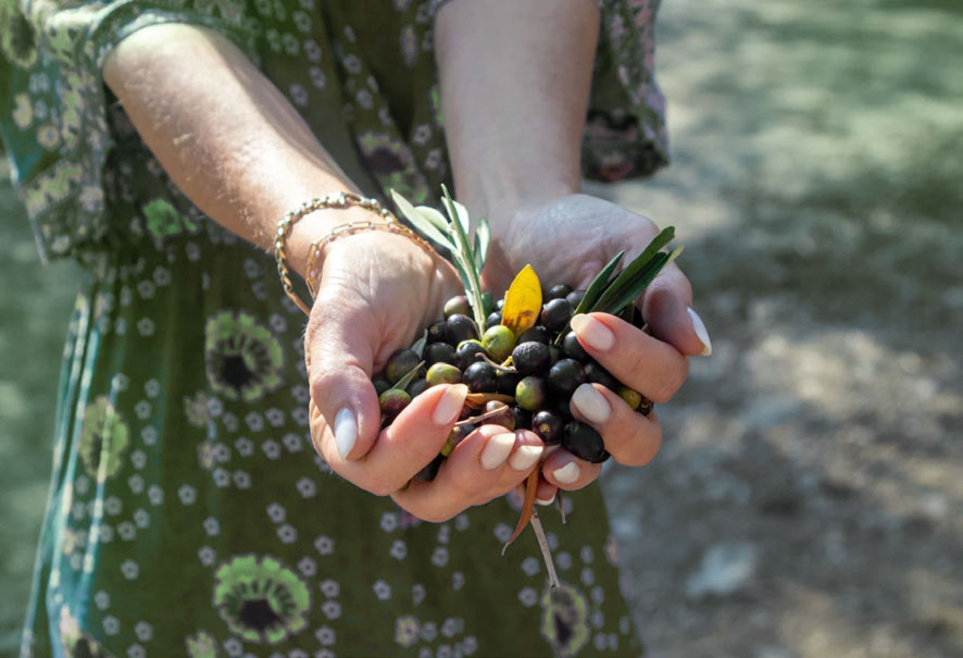 woman holding olives